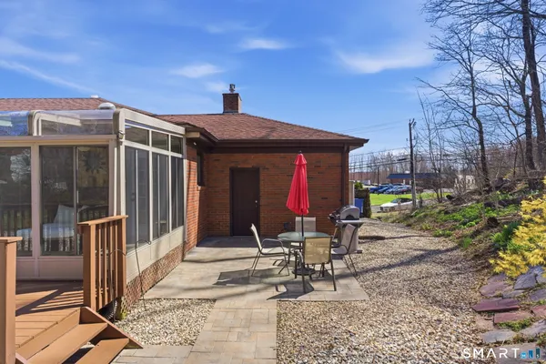 a chair and table in front of a house