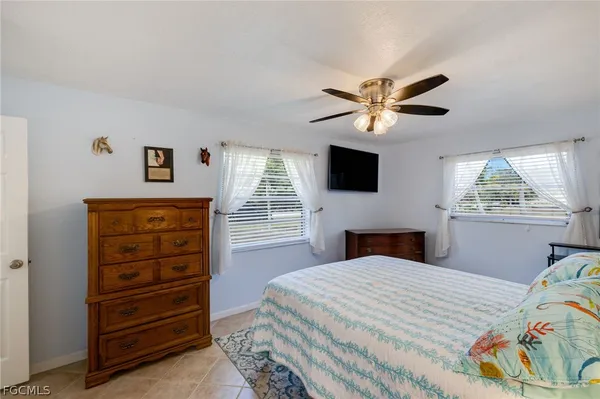 a bedroom with a bed and a tv