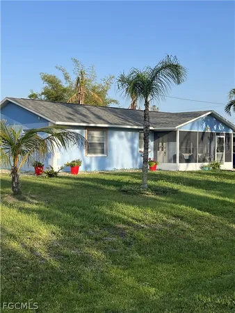 a front view of house with outdoor space and garden