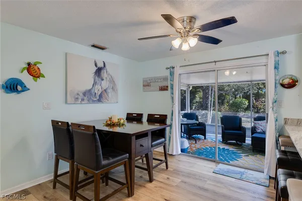 a dining room with furniture a flat screen tv and a large window