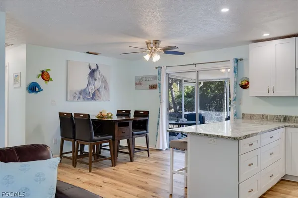 a view of dining table chairs and wooden floor