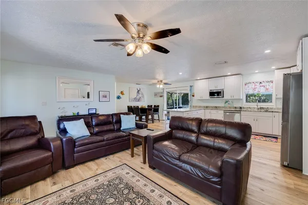a living room with furniture and kitchen view
