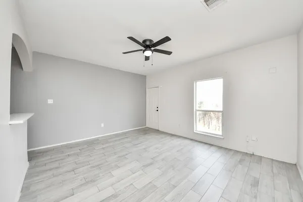 wooden floor in an empty room with a window