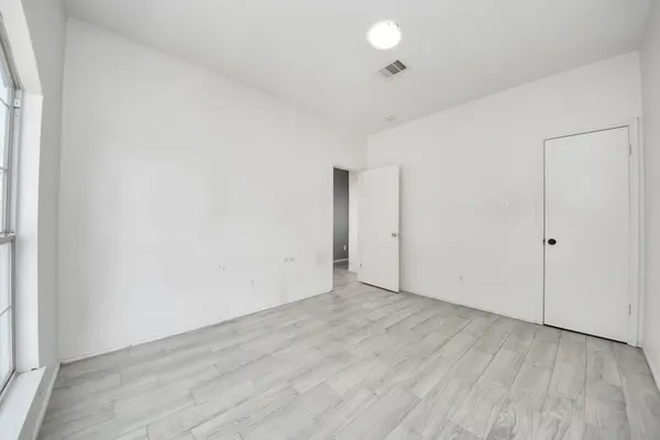 an empty room with wooden floor