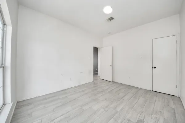 an empty room with wooden floor