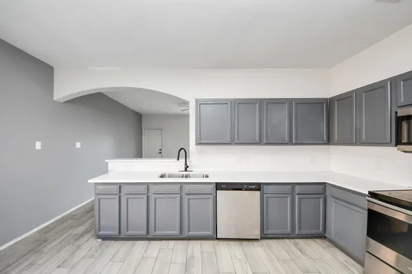 a kitchen with a sink and cabinets