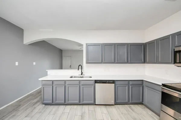 a kitchen with a sink and cabinets