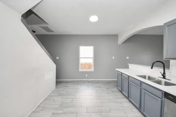a kitchen with a sink and washing machine