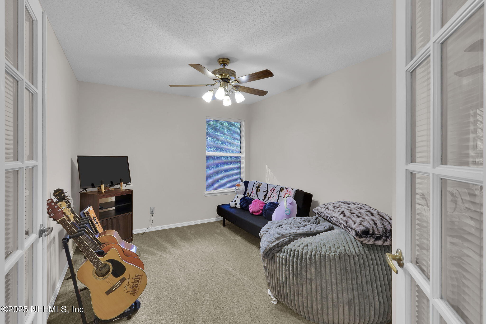 2942 Starshire Cove Jacksonville, FL 32257 - Photo 13 of 21 a bedroom with a bed and a chandelier