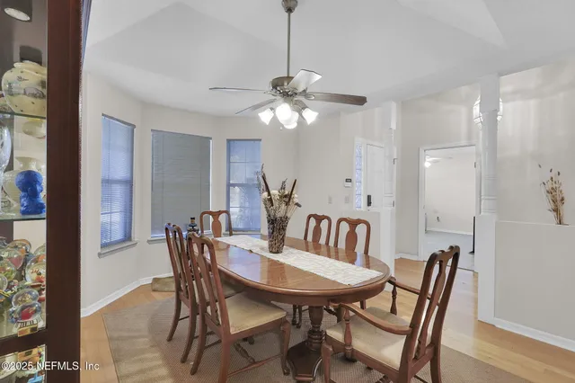 a view of a dining room with furniture and a chandelier