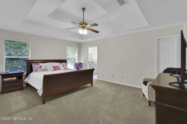 a bed room with a bed and a chandelier