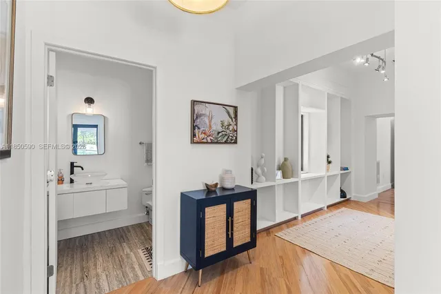 a living room with patio furniture and potted plants
