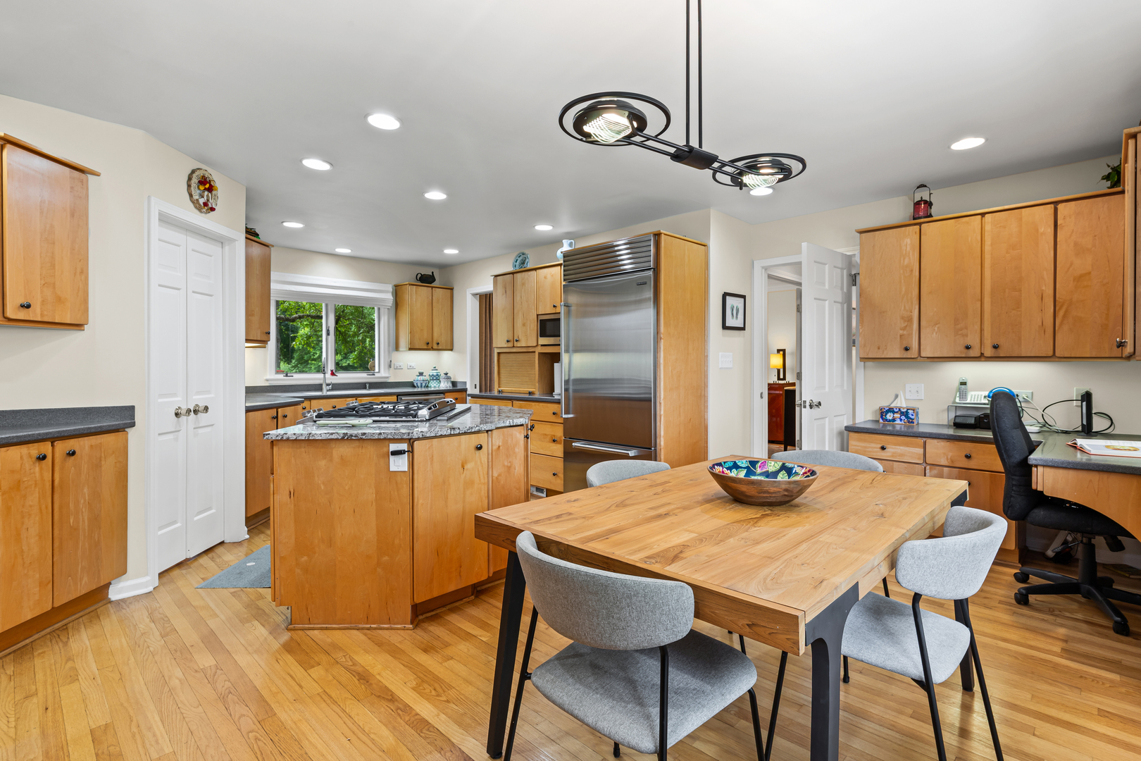 290 Cold Spring Road Barrington, IL 60010 - Photo 11 of 35 a kitchen with stainless steel appliances granite countertop a kitchen island a stove a table and chairs