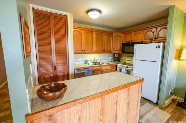 a living room with furniture a ceiling fan a rug and a large window