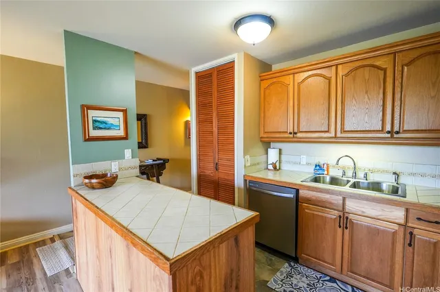 a kitchen with a refrigerator a stove and a wooden cabinets