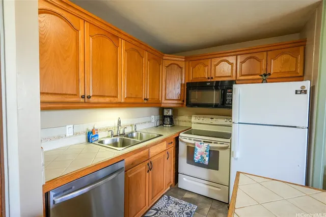 a living room with furniture a flat screen tv and a table