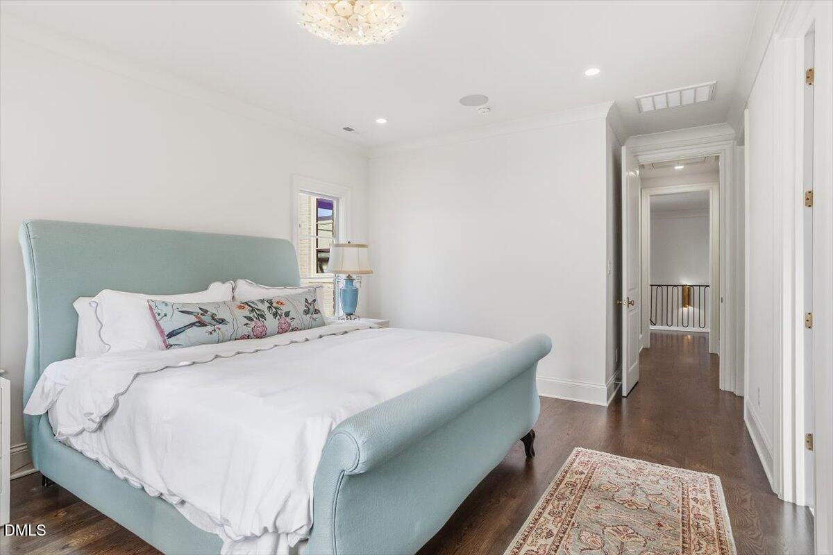 2123 St Marys Street Raleigh, NC 27608 - Photo 51 of 77 a bedroom with a bed and a rug