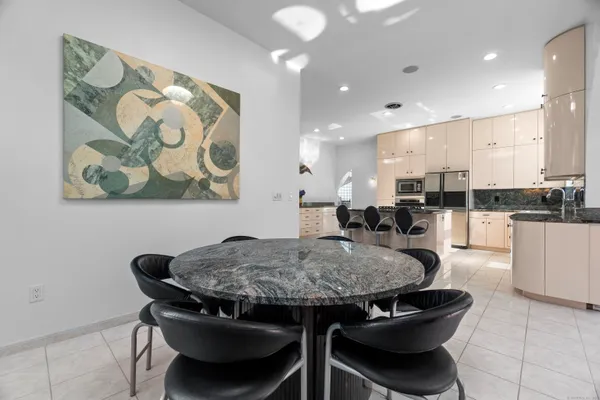 a kitchen with a table and chairs in it