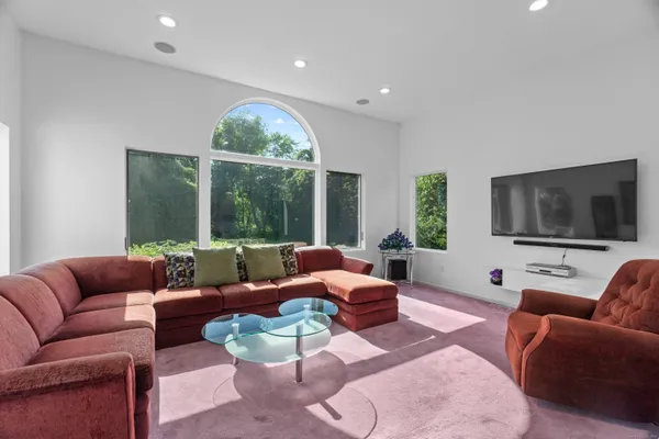 a living room with furniture and a large window