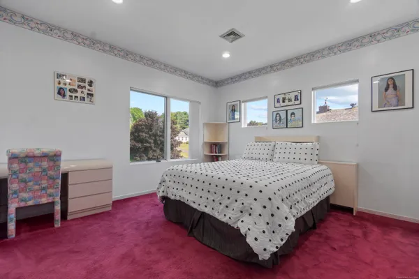 a bedroom with a bed and a dresser