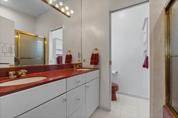 a bathroom with a double vanity sink and a mirror