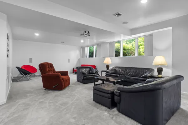 a room with table tennis pool table and couches chairs