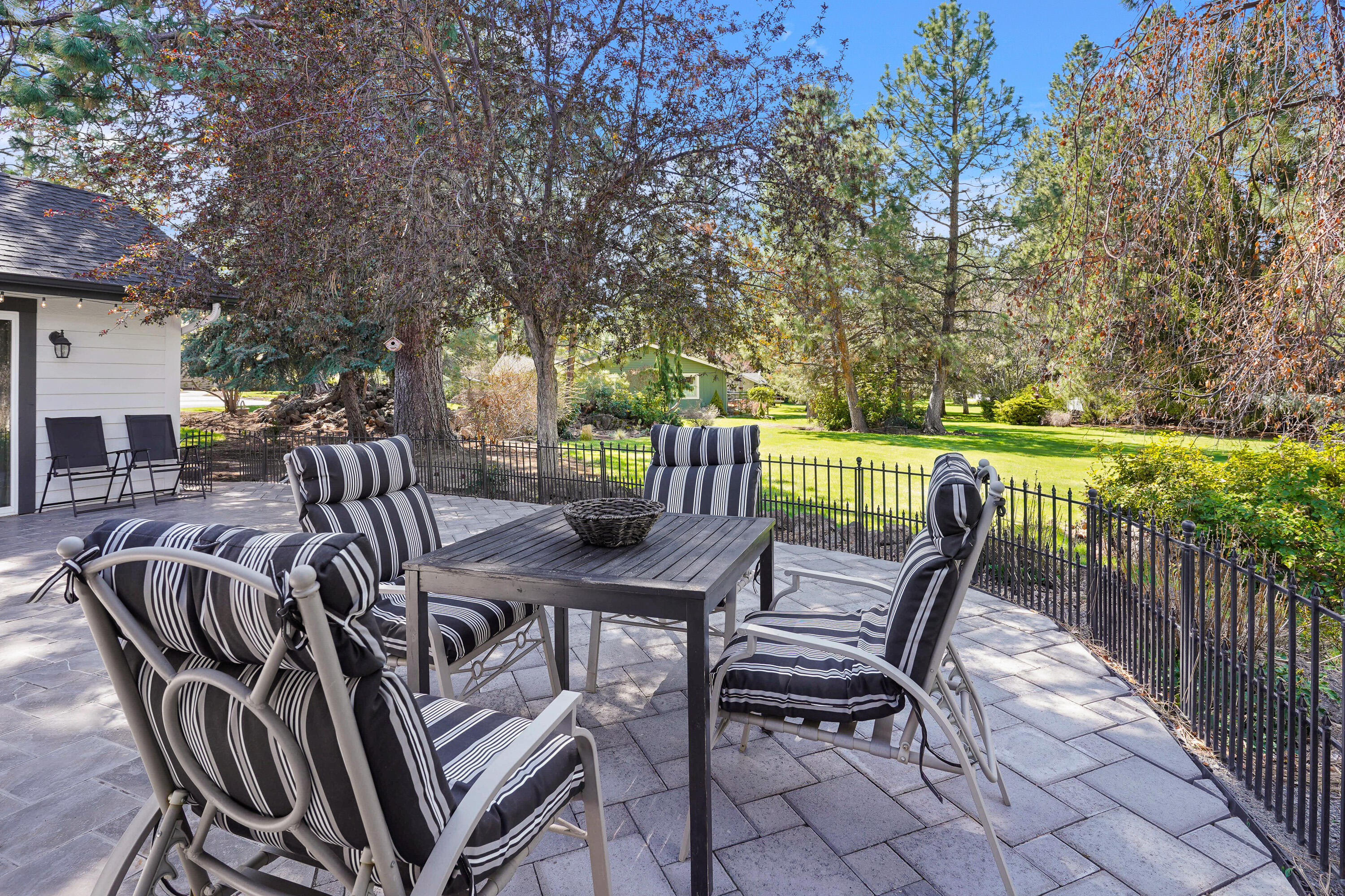 20452 Mainline Road Bend, OR 97702 - Photo 37 of 40 a view of a patio with a table chairs and a backyard