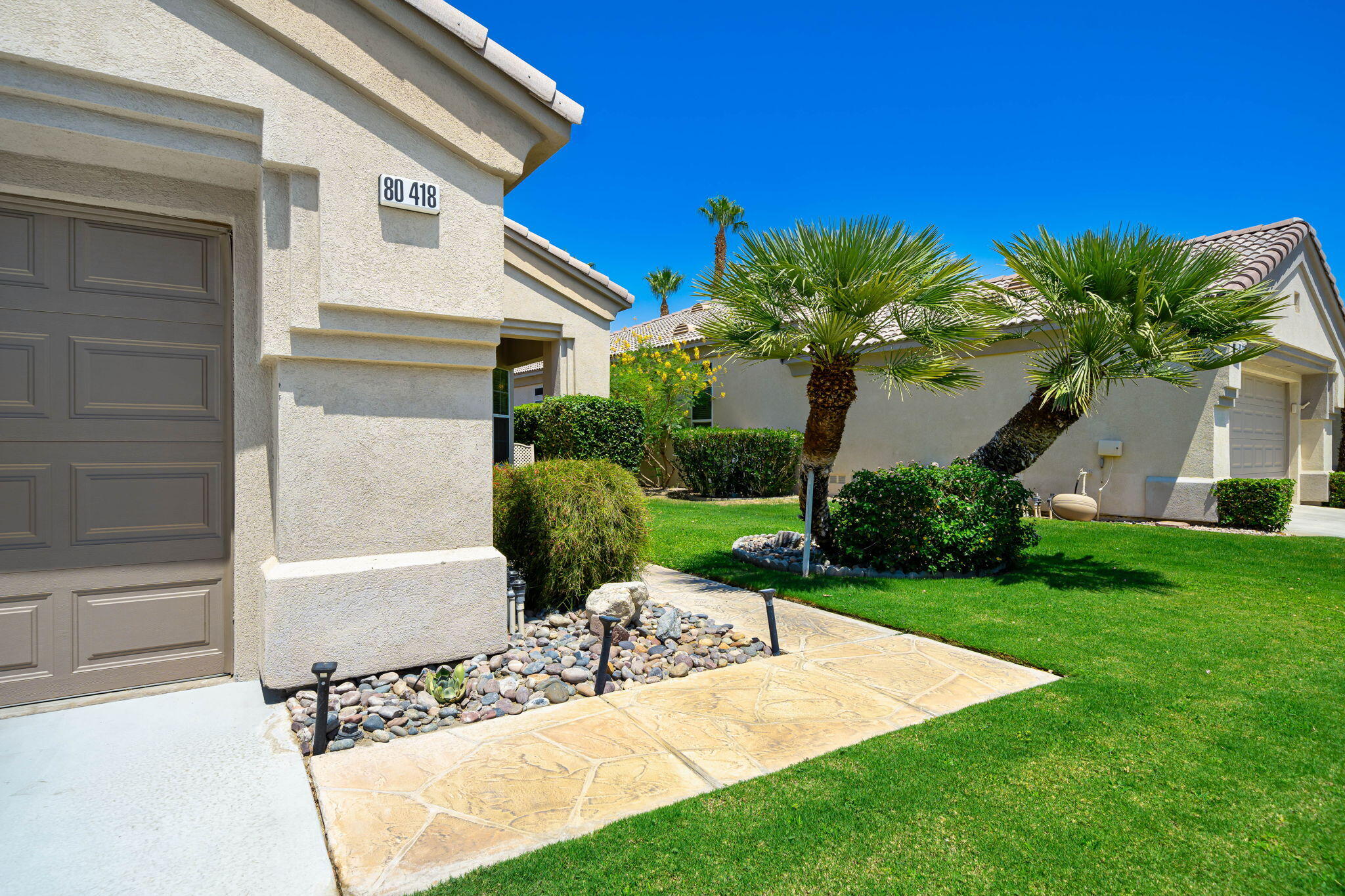80418 Portobello Drive Indio, CA 92201 - Photo 2 of 51 a front view of a house with garden