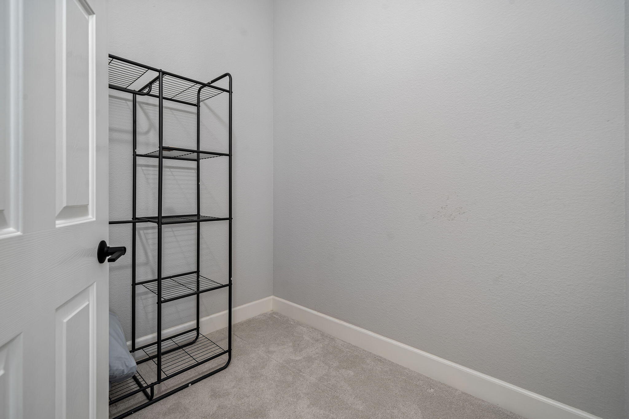 80418 Portobello Drive Indio, CA 92201 - Photo 23 of 51 an empty room with wooden floor and windows