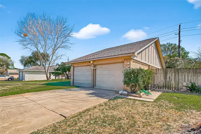 a view of a house with a yard and potted plants