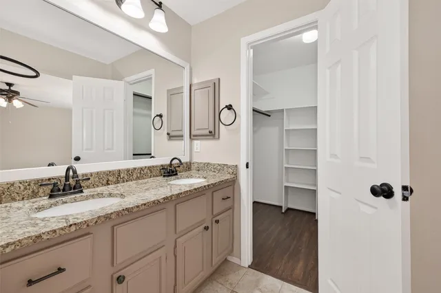 a bathroom with a granite countertop sink mirror and double