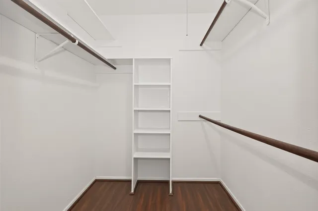 a view of walk in closet with empty racks