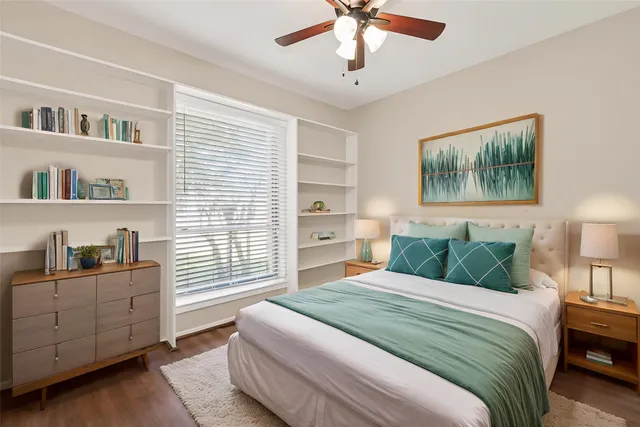 a bedroom with a large bed and a chandelier