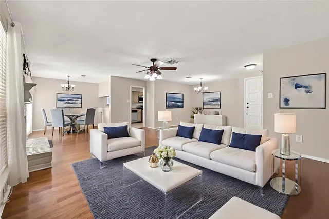 a living room with furniture and a wooden floor