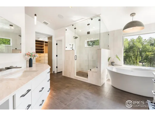 a spacious bathroom with a granite countertop tub sink and mirror