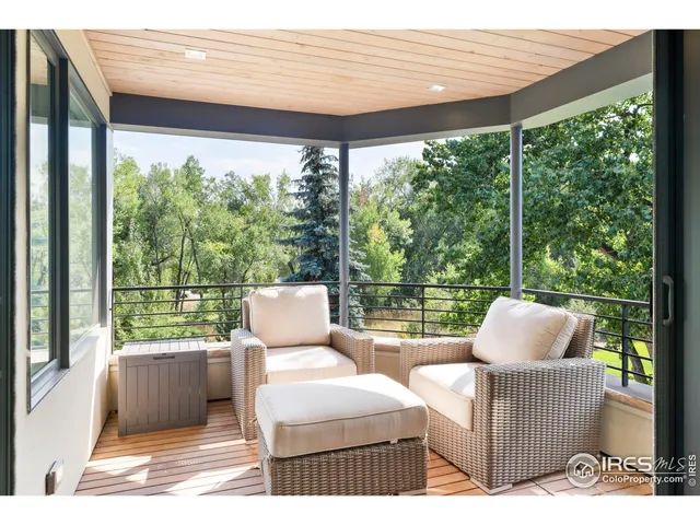 a balcony with furniture and a garden