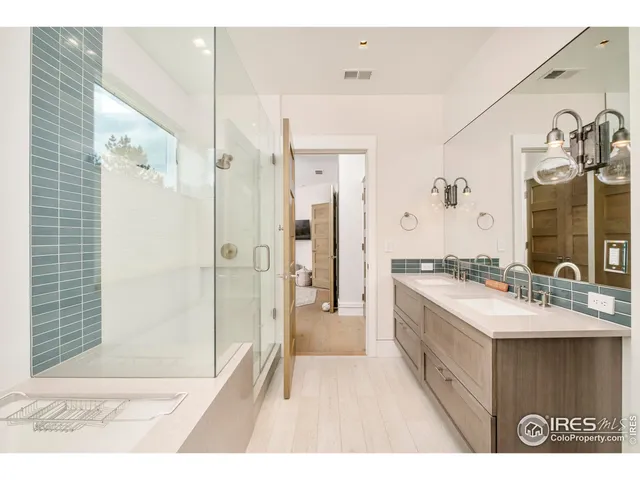 a large bathroom with a sink mirror and shower