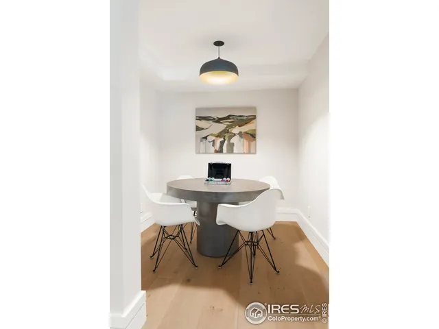 a view of a hallway with a table and a chandelier