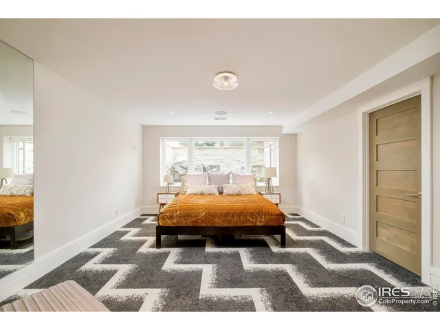 a bed room with a bed window and a flat screen tv