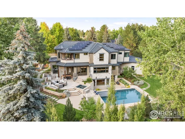 a view of a house with pool and chairs