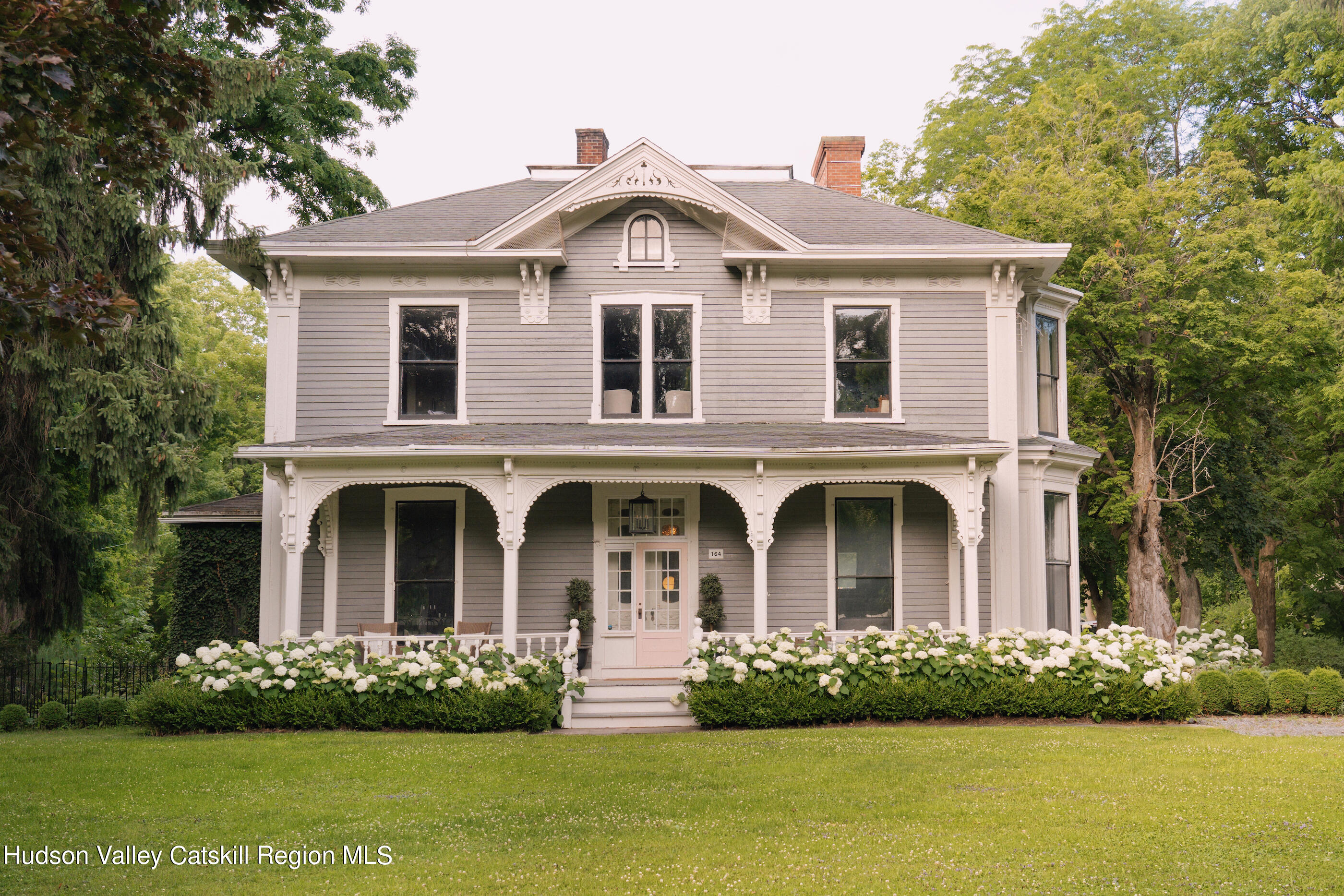 164 River Street Middleburgh, NY 12122 - Photo 2 of 48 a front view of a house with a garden and plants