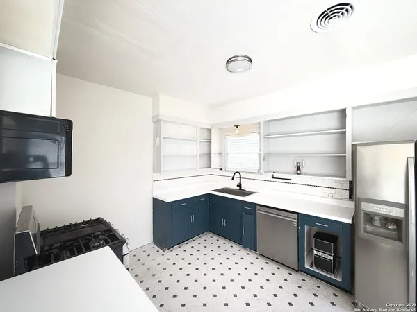 a kitchen with a sink a stove and refrigerator