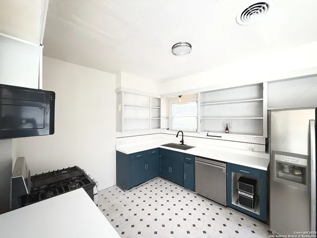 a kitchen with a sink a stove and refrigerator