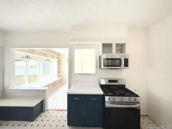 a kitchen with a sink cabinets and a window