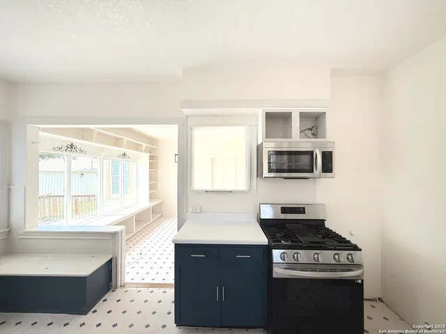 a kitchen with a sink cabinets and a window