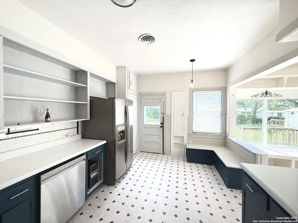 a bathroom with a toilet sink double vanity and mirror