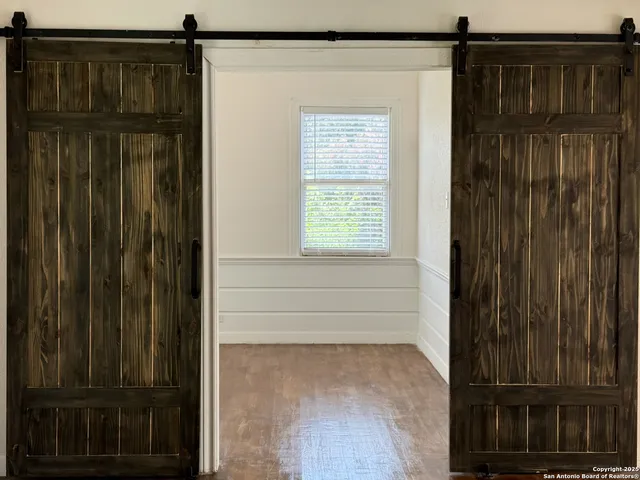 a view of house with a deck and furniture