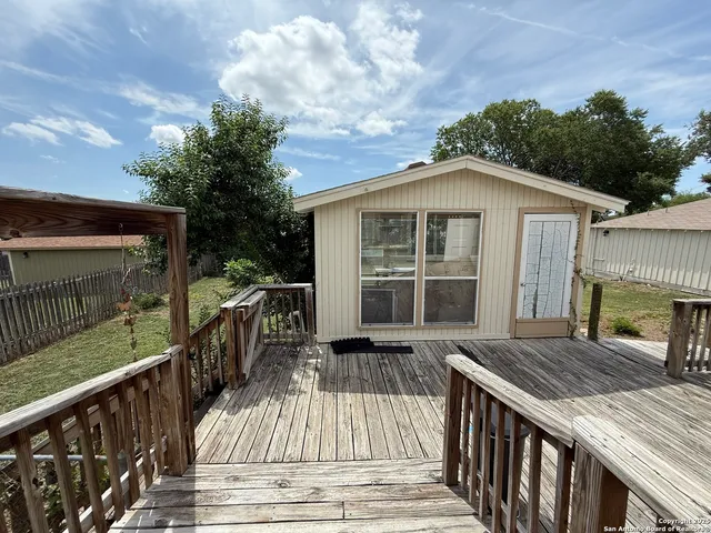 a view of a house with wooden deck