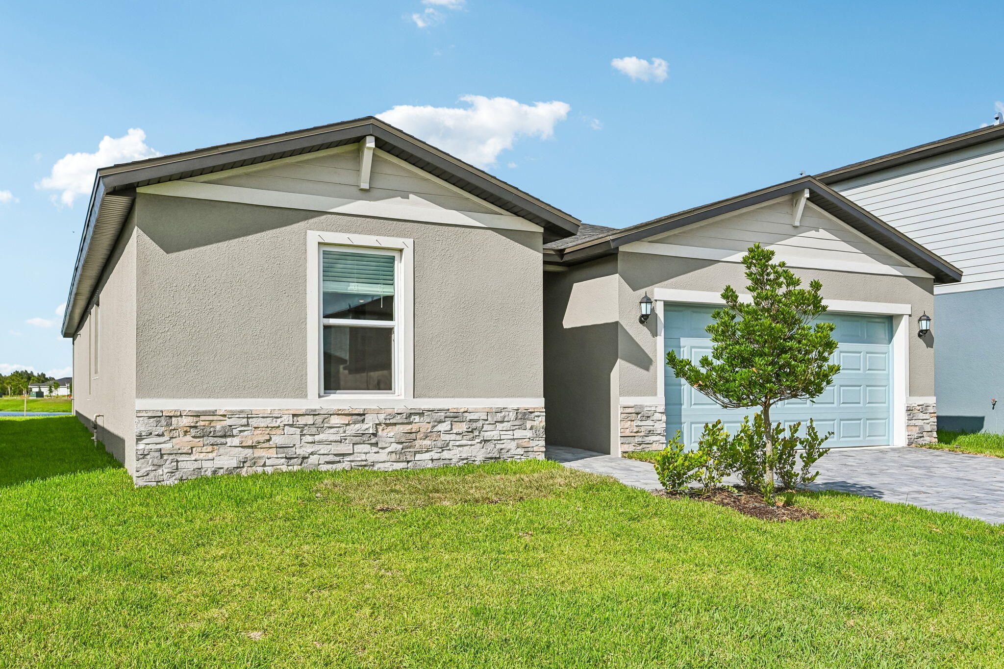 14503 Southwest New Dawn Road Indiantown, FL 34956 - Photo 2 of 42 a front view of a house with a yard
