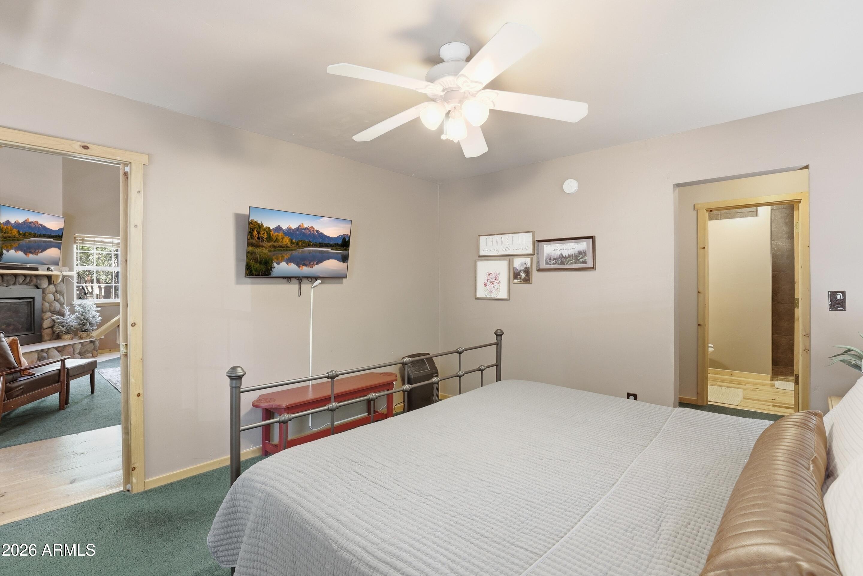6322 Sharyn Road Pine, AZ 85544 - Photo 16 of 37 a bedroom with a bed and a chandelier